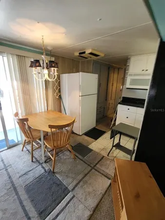 a view of a dining room with furniture and a rug