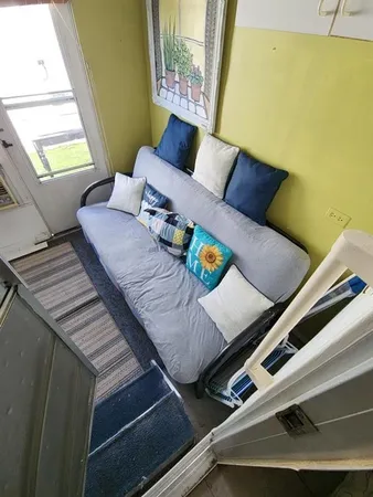a view of a living room with furniture and a window