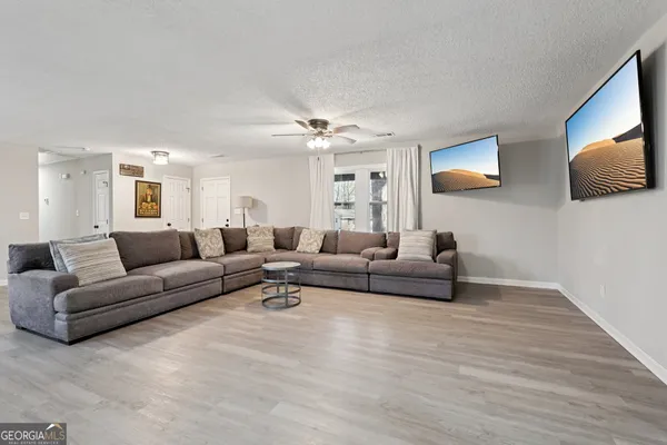 a living room with furniture and a wooden floor