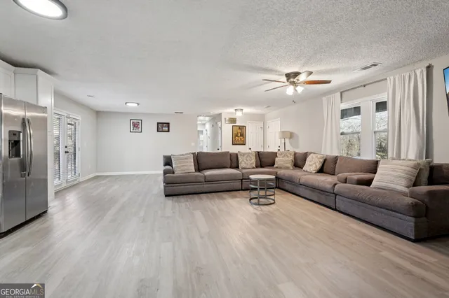 a living room with furniture and a chandelier