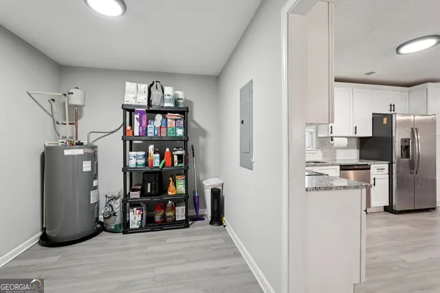 a view of a kitchen with fridge and wooden floor