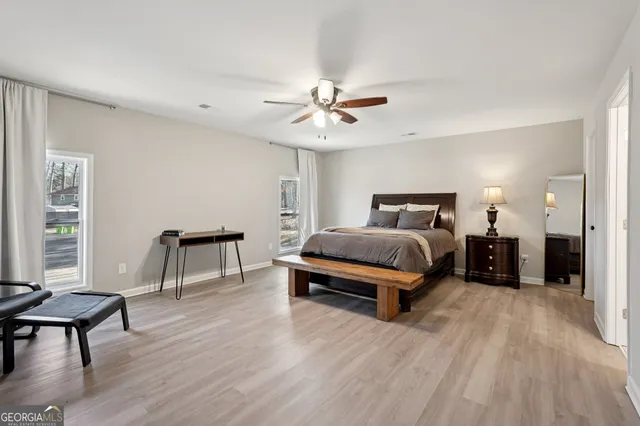 a bedroom with a bed a chandelier and window