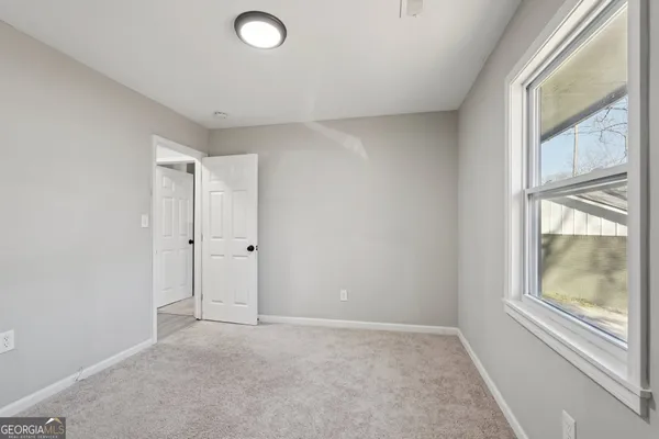 a view of an empty room with a window