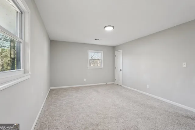 a bathroom with a granite countertop sink a mirror and shower