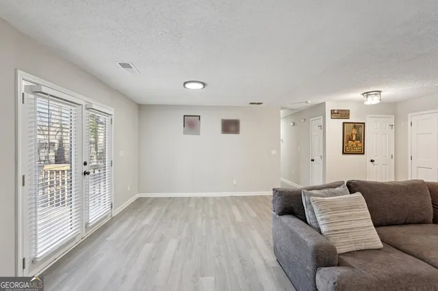 a living room with furniture and a large window
