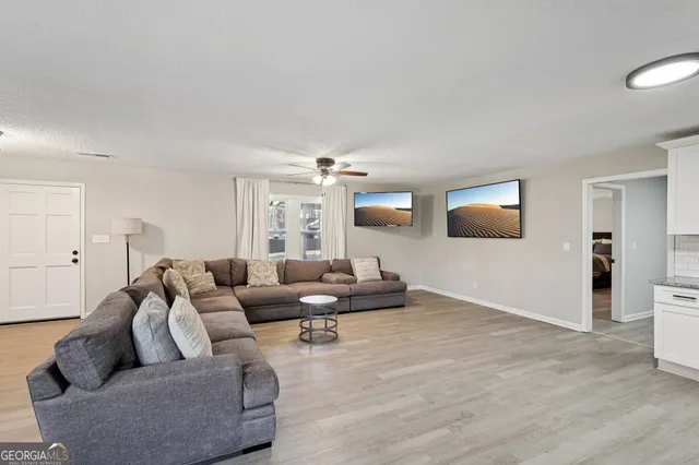 a living room with furniture and a flat screen tv
