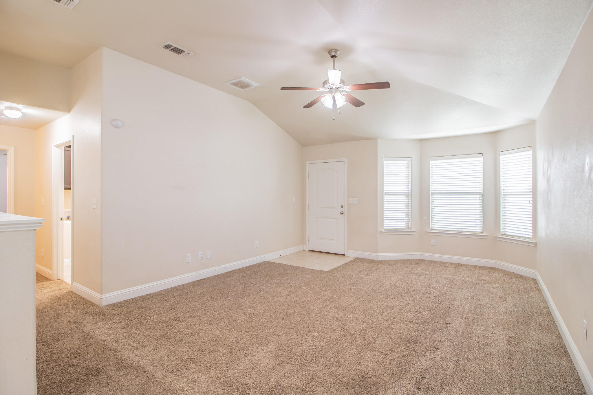 7409 101st Street Lubbock, TX 79424 - Photo 3 of 22 a view of an empty room with a window