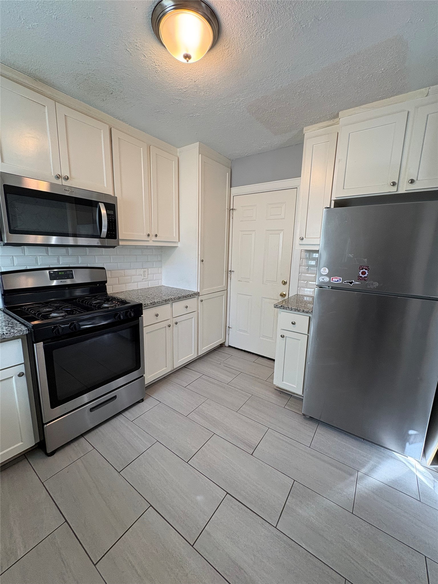 943 West 43rd Street Houston, TX 77018 - Photo 7 of 10 a kitchen with stainless steel appliances granite countertop a sink and cabinets