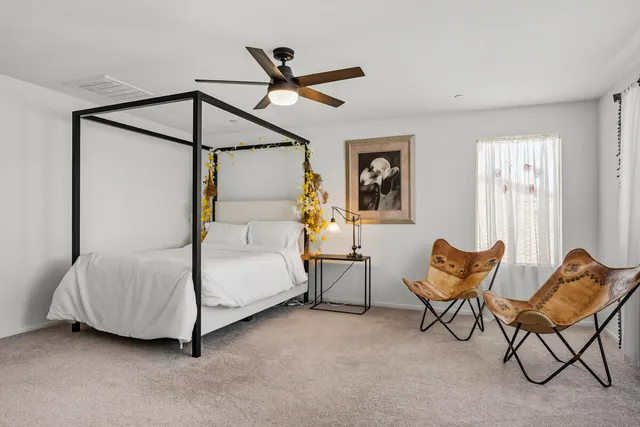 a bedroom with furniture and a window