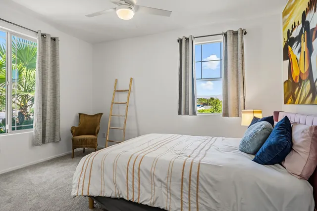 a bedroom with a bed and a large window