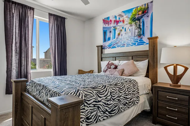 a bed sitting in a bedroom next to a window