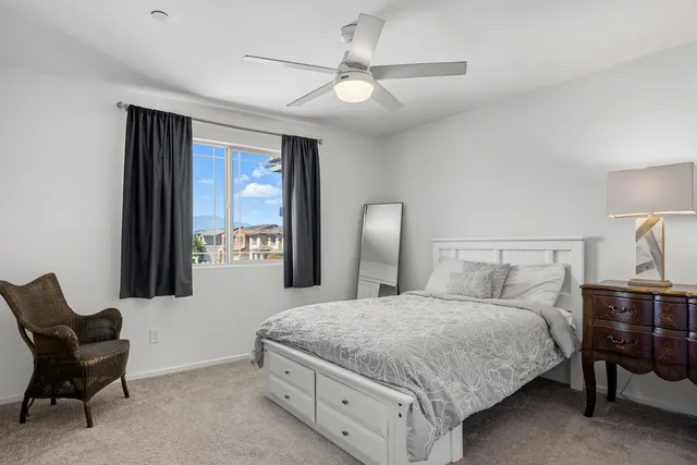 a bedroom with a bed and a chair