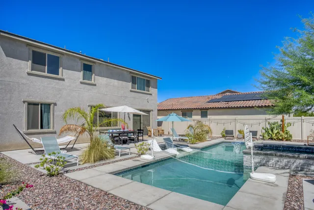 a view of a patio with table and chairs with wooden fence