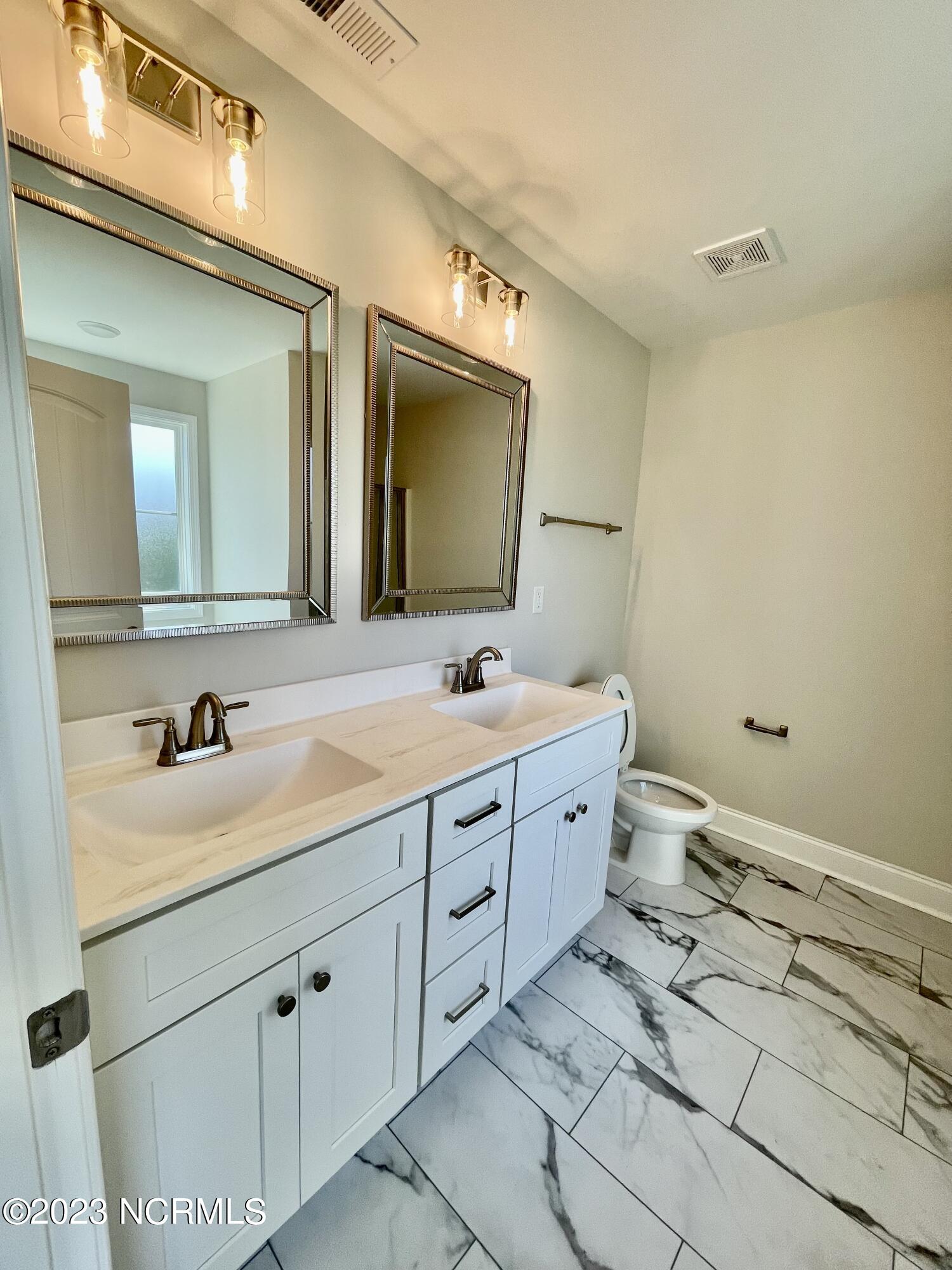 45 Morningdew Way Spring Hope, NC 27882 - Photo 18 of 29 Owners suite bathroom w/ Dble vanity and luxury vinyl flooring