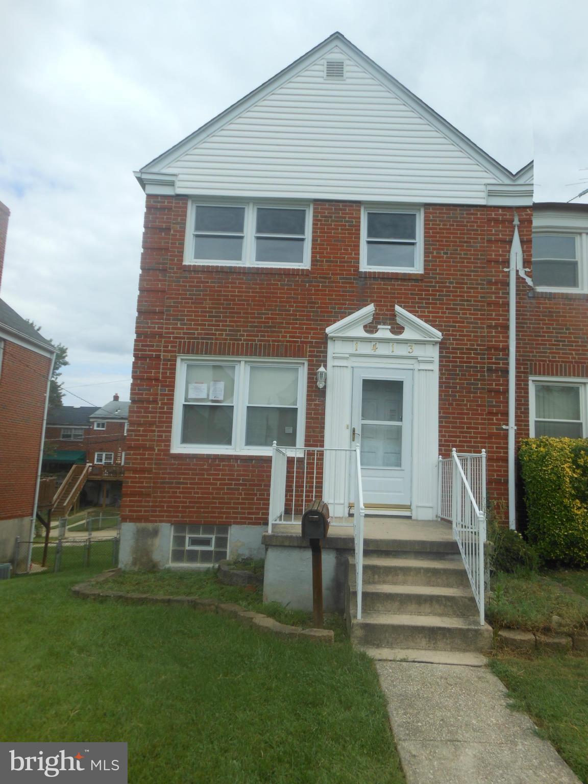 1413 Barrett Road Baltimore, MD 21207 - Photo 1 of 13 a front view of a house with a yard