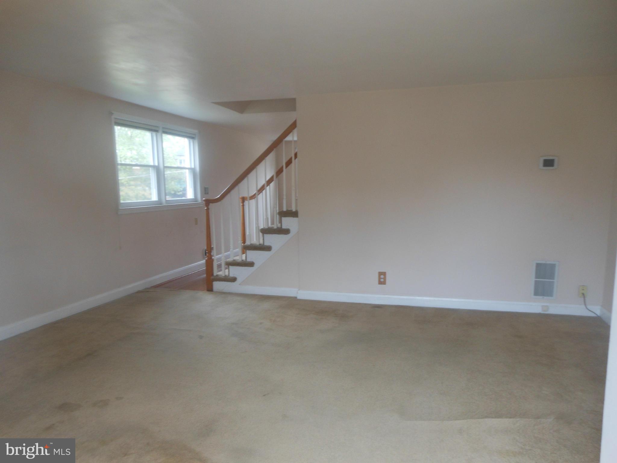 1413 Barrett Road Baltimore, MD 21207 - Photo 3 of 13 a view of an empty room with stairs