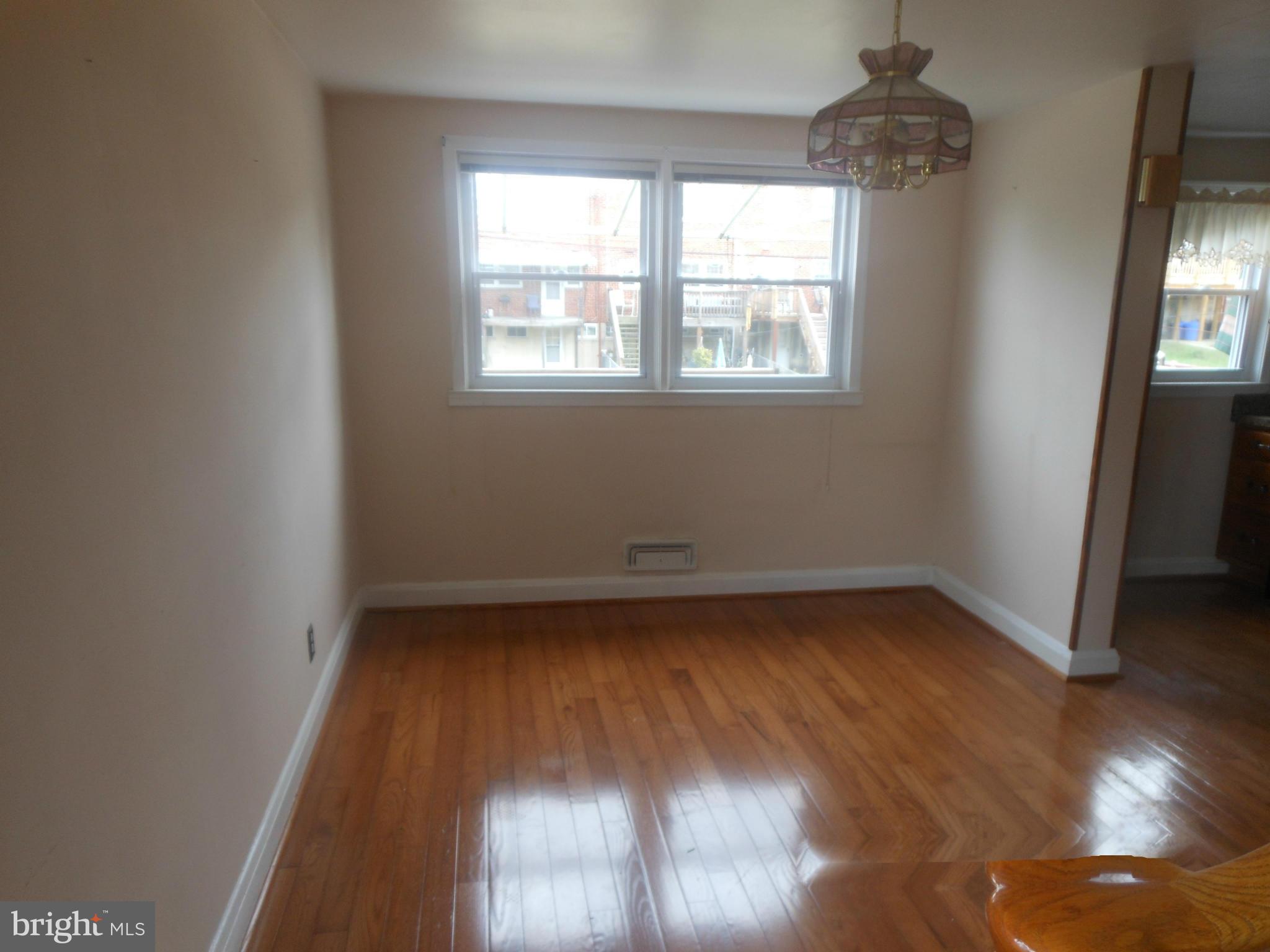 1413 Barrett Road Baltimore, MD 21207 - Photo 5 of 13 wooden floor in an empty room with a window
