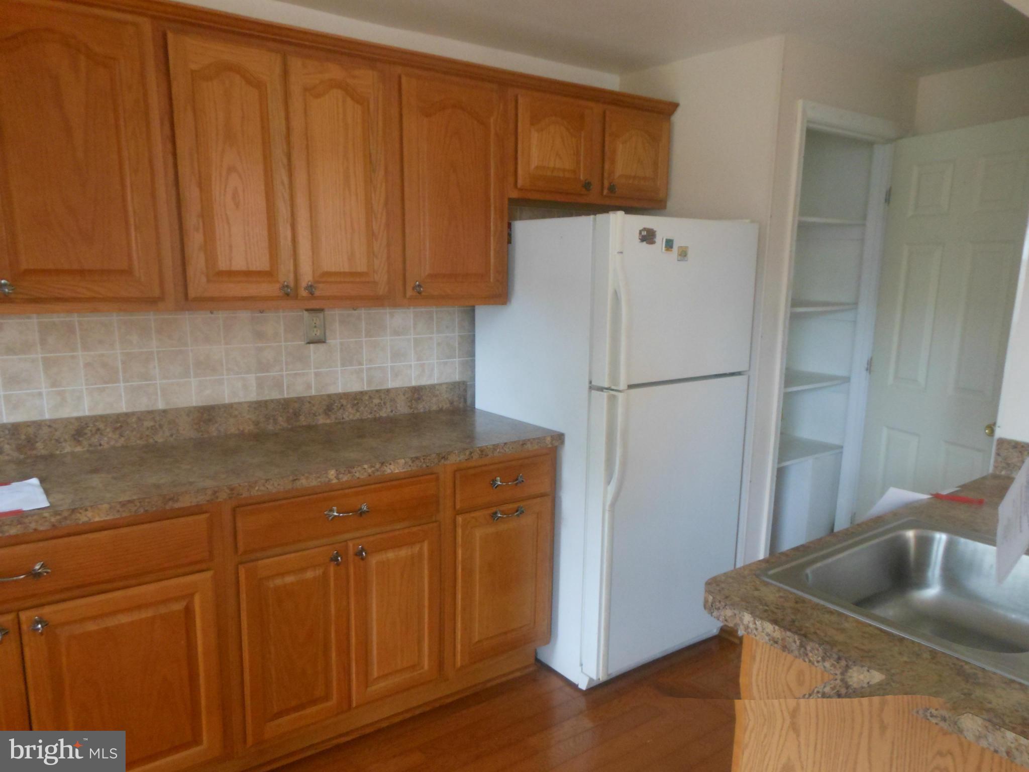 1413 Barrett Road Baltimore, MD 21207 - Photo 7 of 13 a kitchen with stainless steel appliances granite countertop a refrigerator a sink and dishwasher