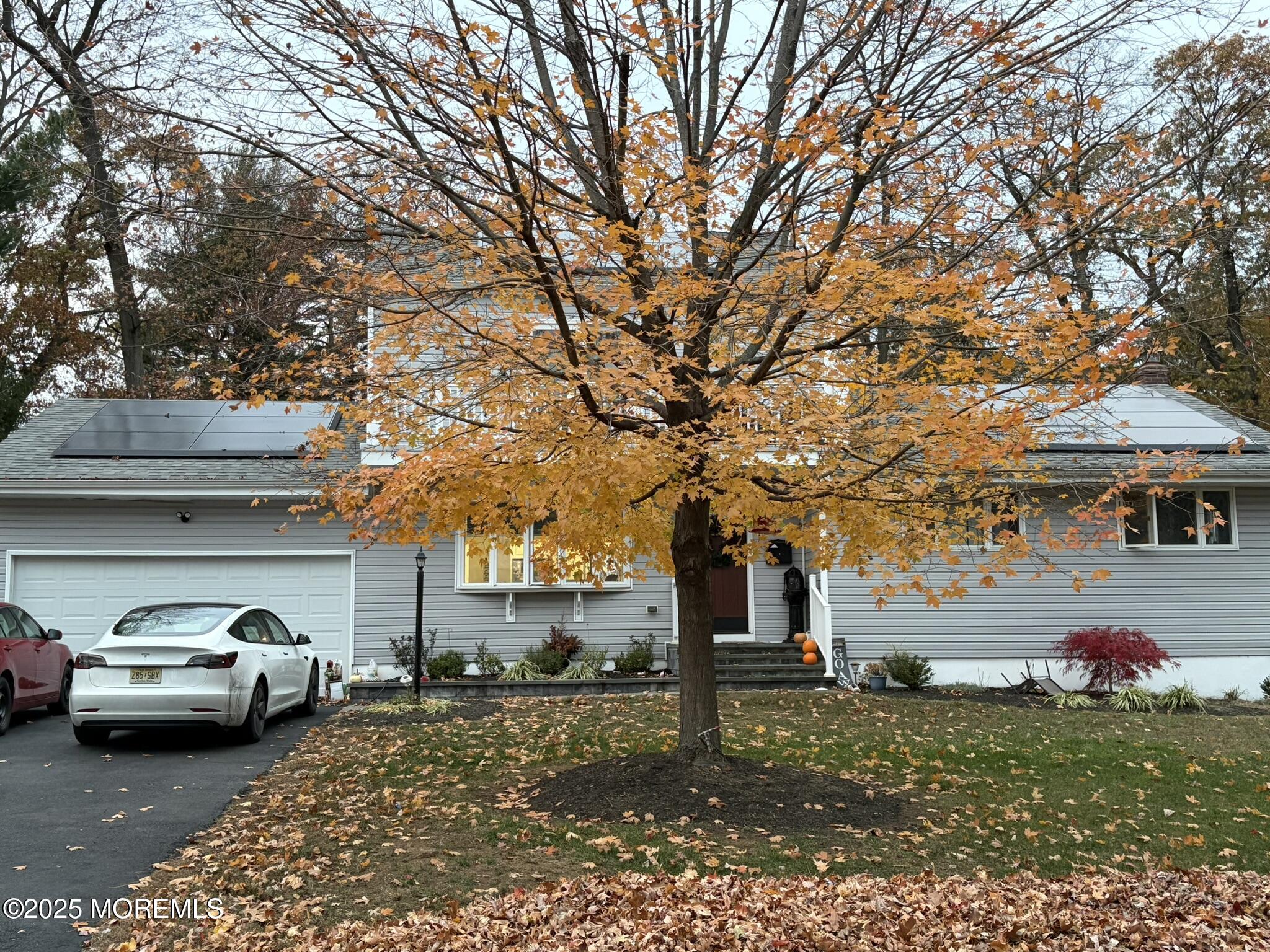a couple of cars parked in front of a house