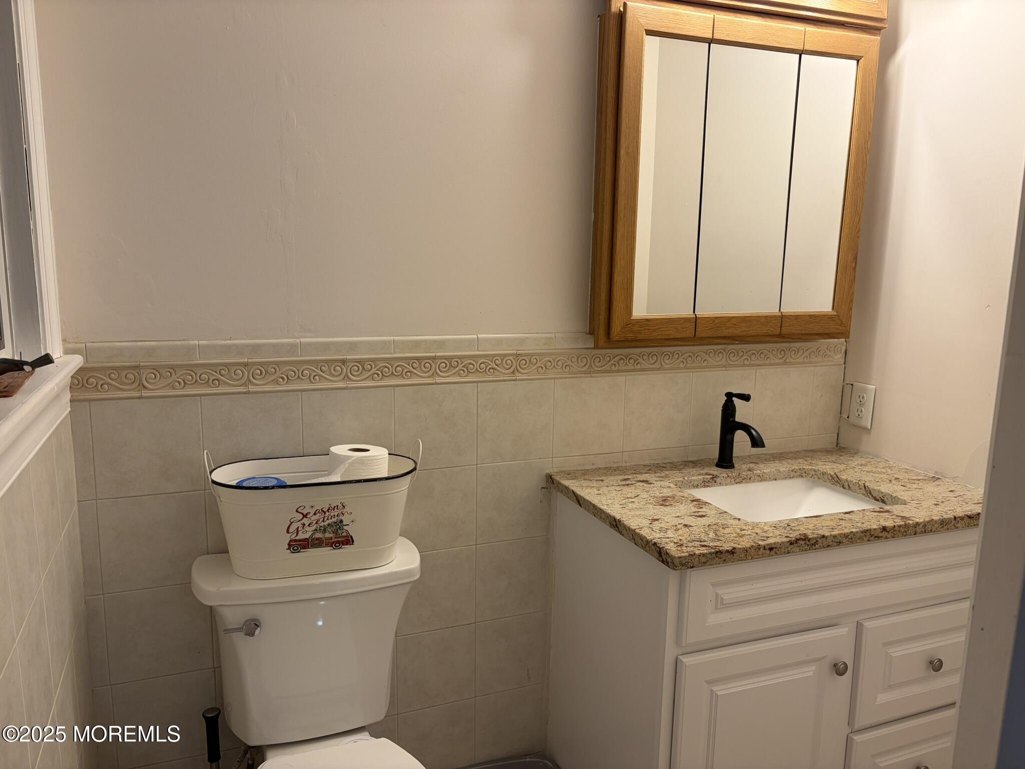 11 Chestnut Ridge Road Holmdel, NJ 07733 - Photo 16 of 44 a bathroom with a granite countertop toilet sink and mirror