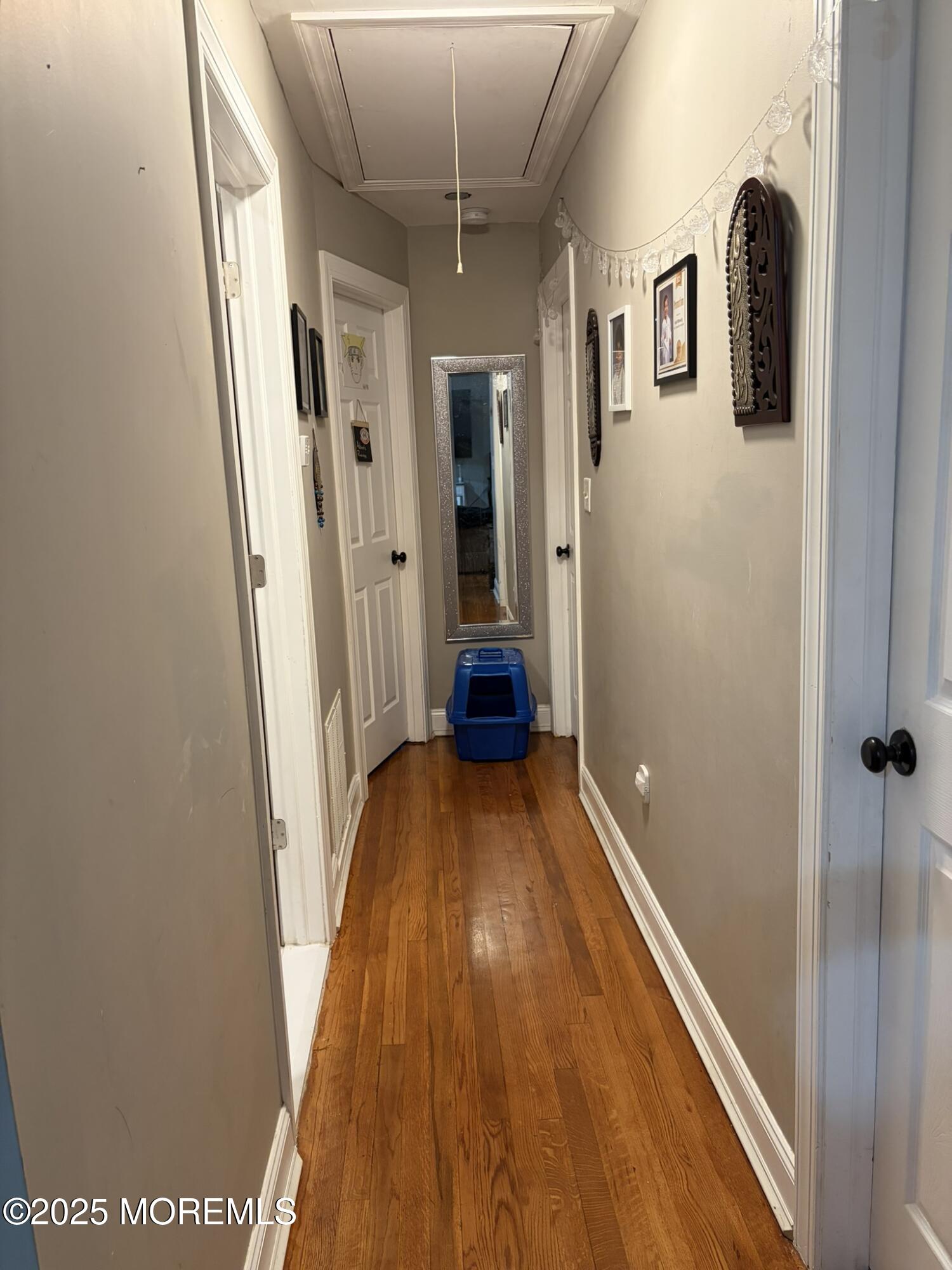 11 Chestnut Ridge Road Holmdel, NJ 07733 - Photo 29 of 44 a view of a hallway with wooden floor and staircase