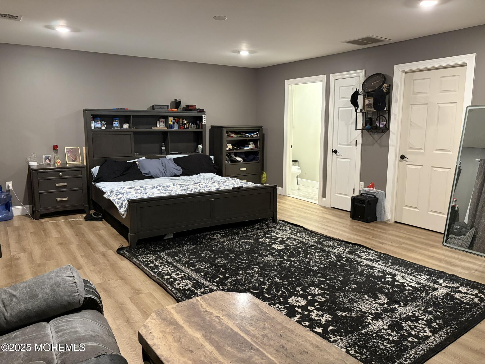 11 Chestnut Ridge Road Holmdel, NJ 07733 - Photo 39 of 44 a bedroom with a bed and wooden floor