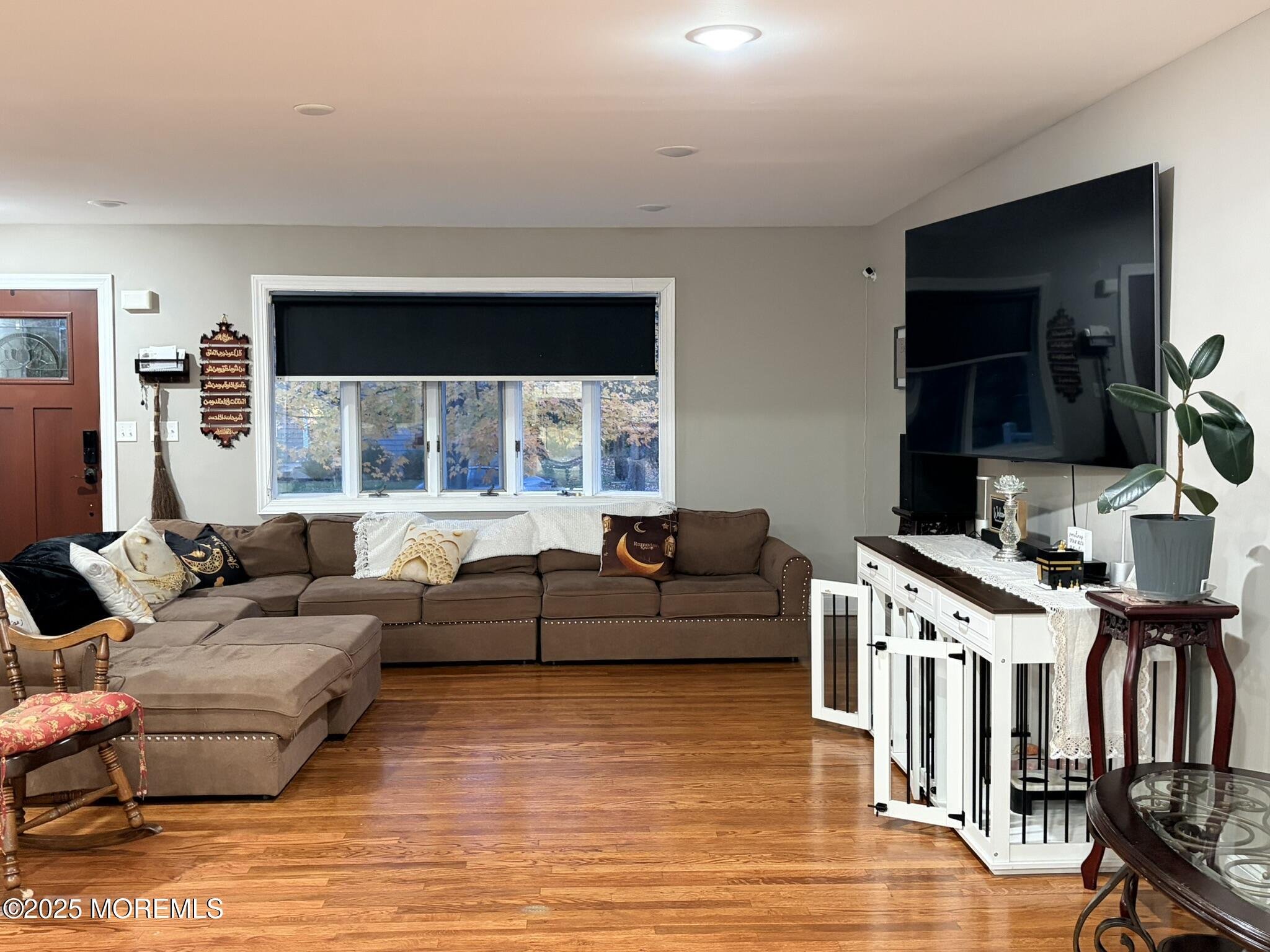 11 Chestnut Ridge Road Holmdel, NJ 07733 - Photo 6 of 44 a living room with furniture a flat screen tv and kitchen view