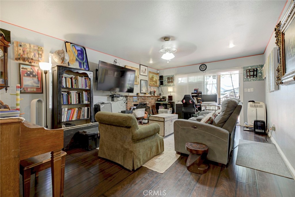 1029 East Galatea Street Azusa, CA 91702 - Photo 24 of 36 a living room with furniture and a book shelf