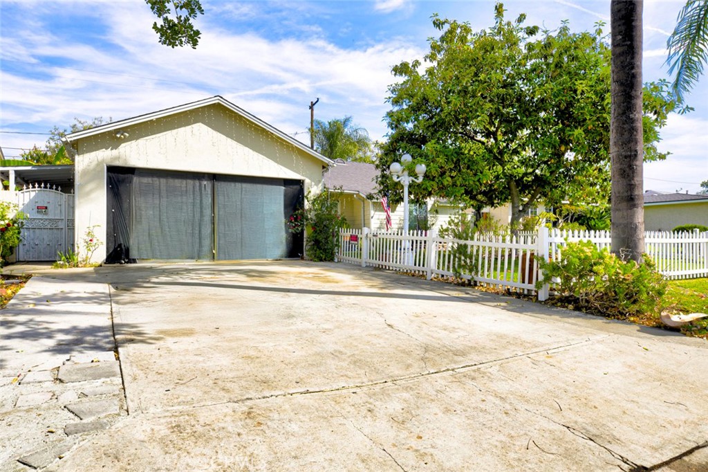 1029 East Galatea Street Azusa, CA 91702 - Photo 3 of 36 a view of yellow house with a yard and plants