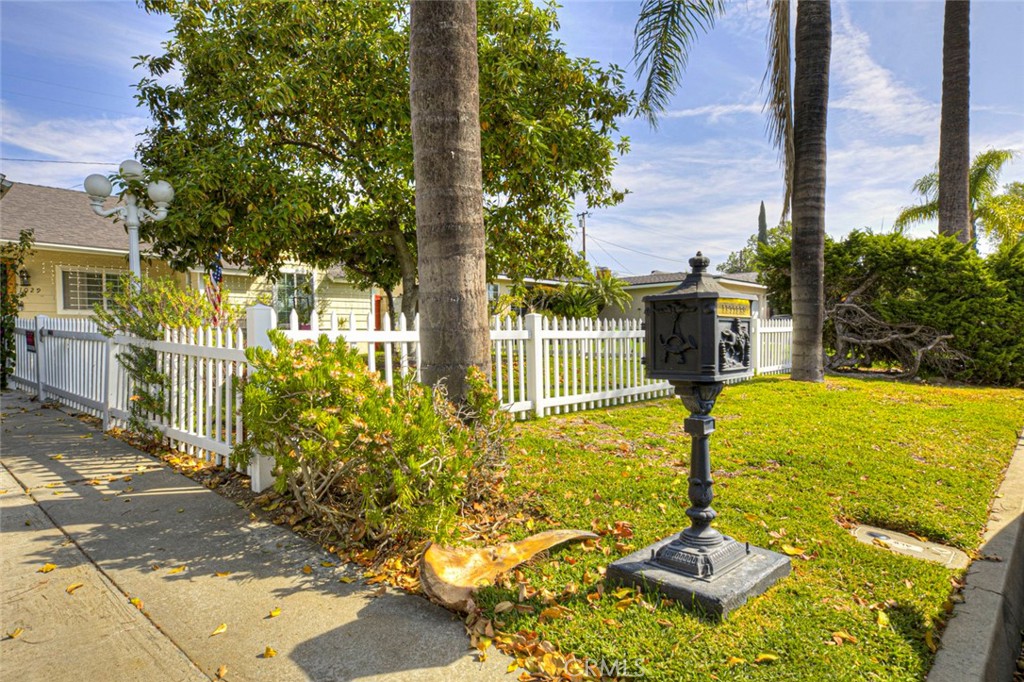 1029 East Galatea Street Azusa, CA 91702 - Photo 8 of 36 a front view of a house with yard fountain and large tree
