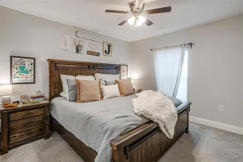 a bedroom with a bed and a chandelier