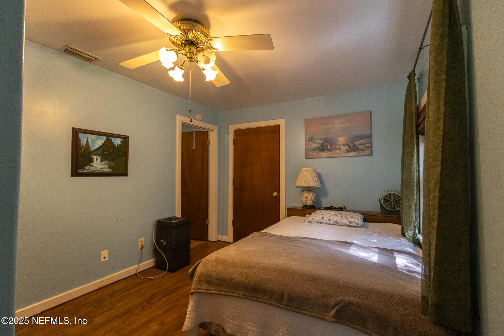 128 Devils Elbow Palatka, FL 32177 - Photo 13 of 38 a bedroom with a bed and a chandelier