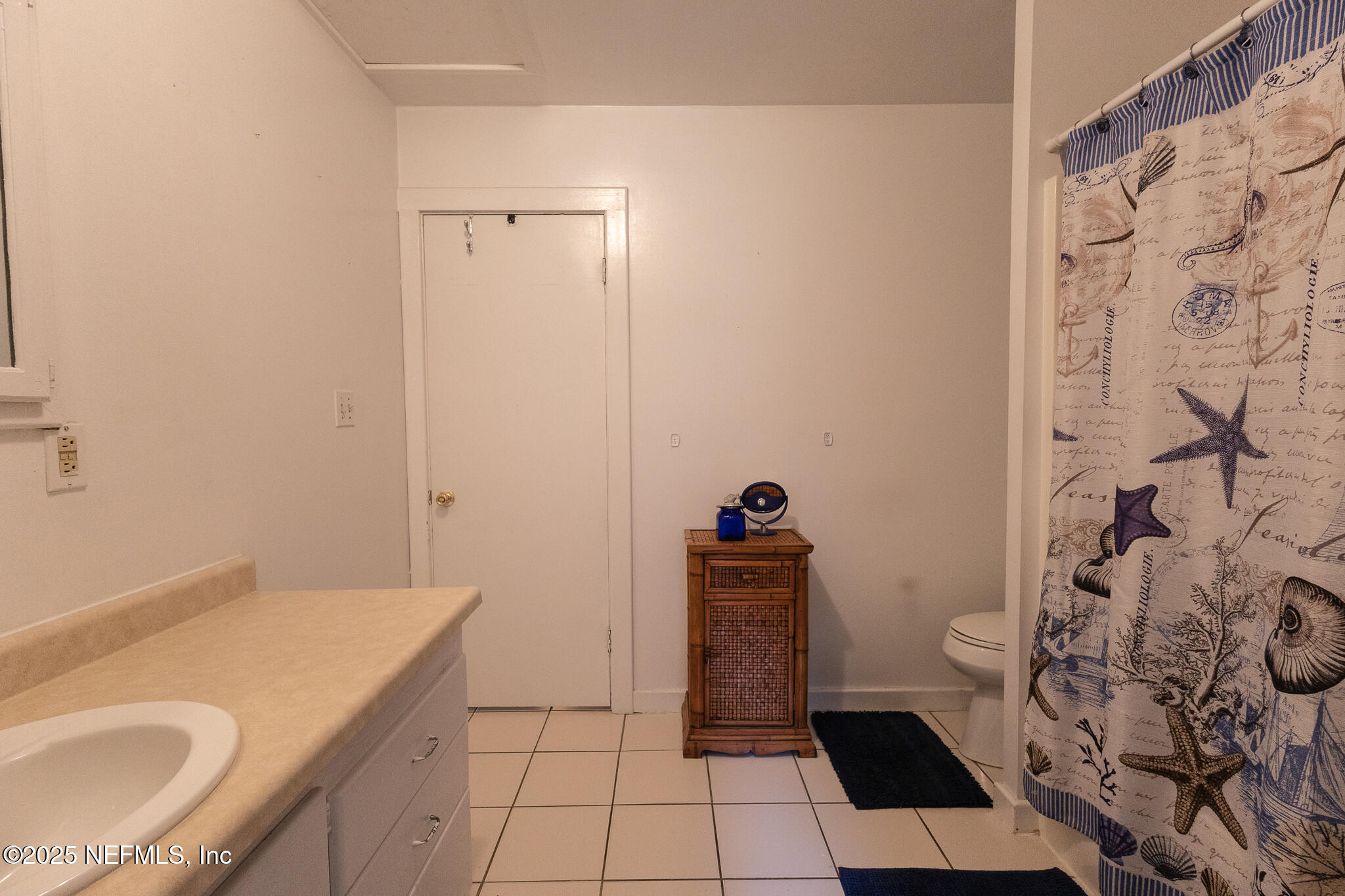 128 Devils Elbow Palatka, FL 32177 - Photo 16 of 38 a bathroom with a granite countertop sink and a shower curtain