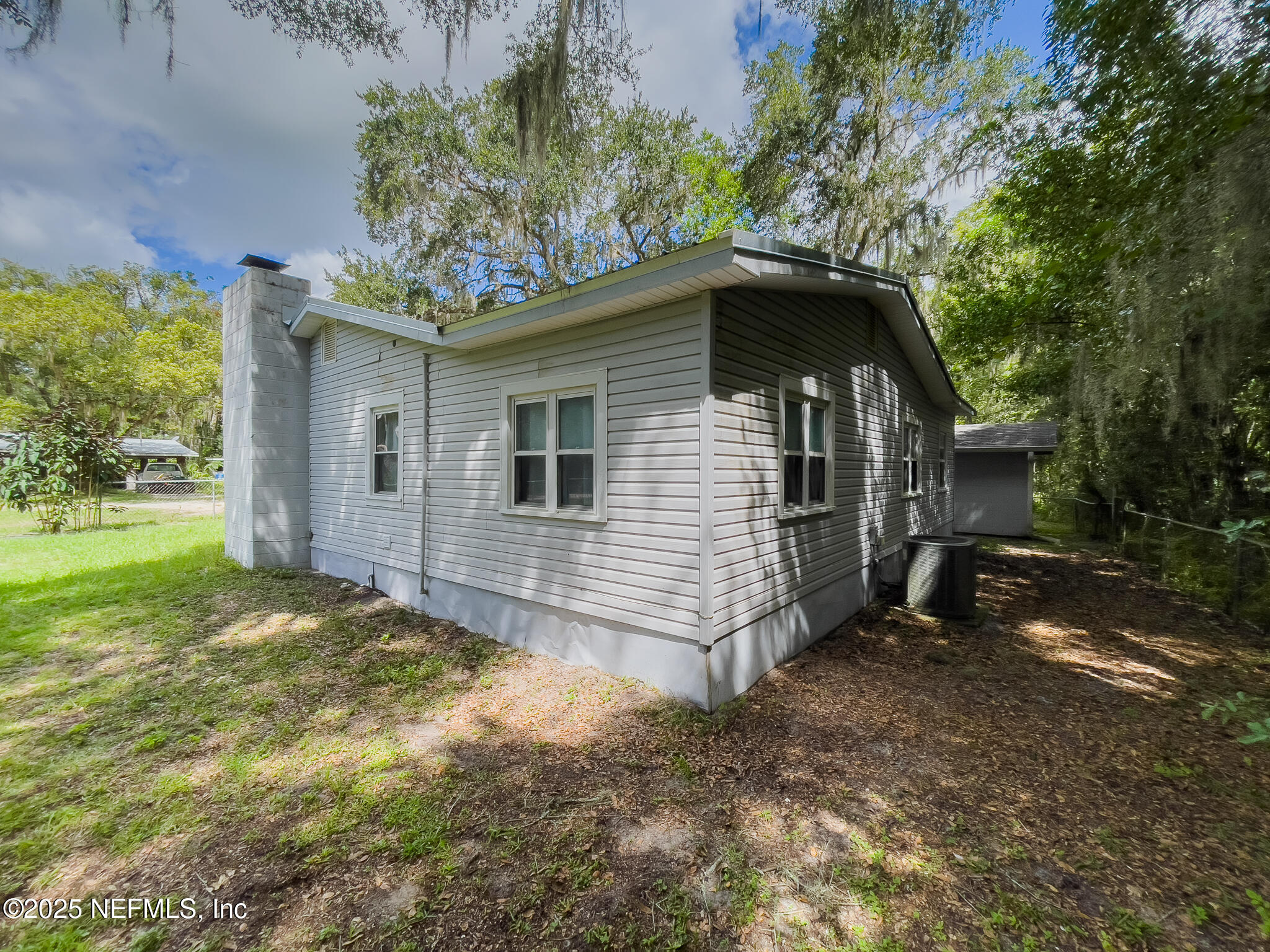 128 Devils Elbow Palatka, FL 32177 - Photo 21 of 38 a view of a house with yard and a tree