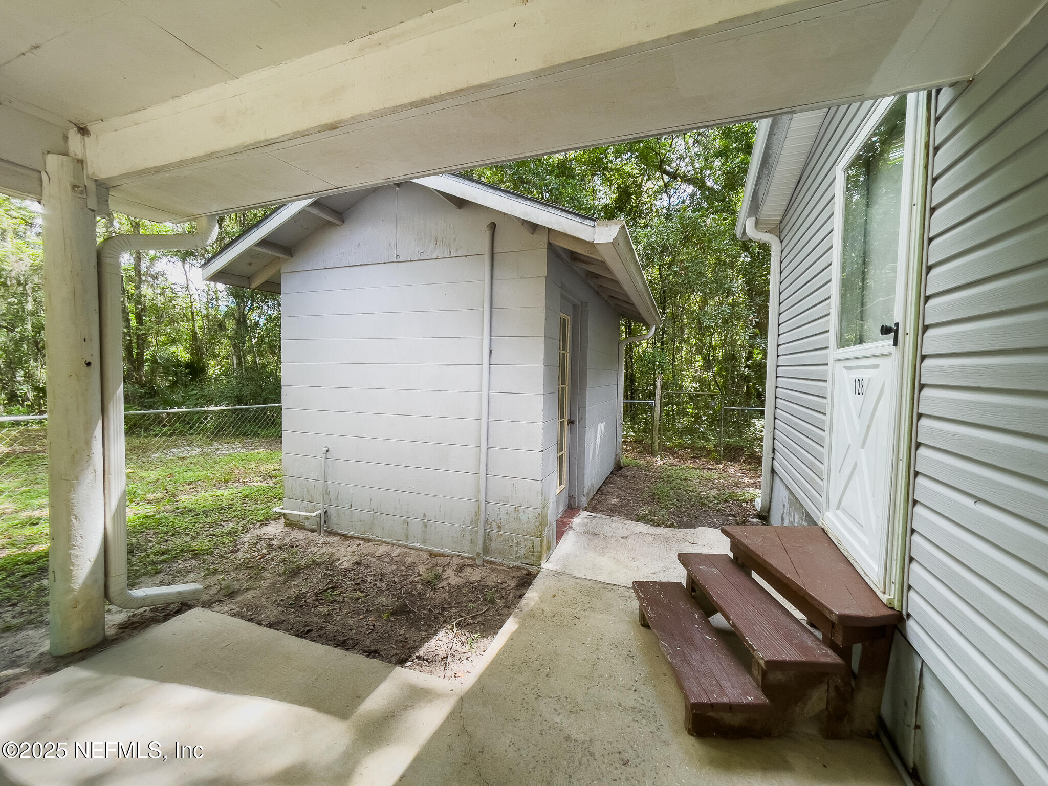 128 Devils Elbow Palatka, FL 32177 - Photo 24 of 38 a backyard of a house with outdoor seating and yard