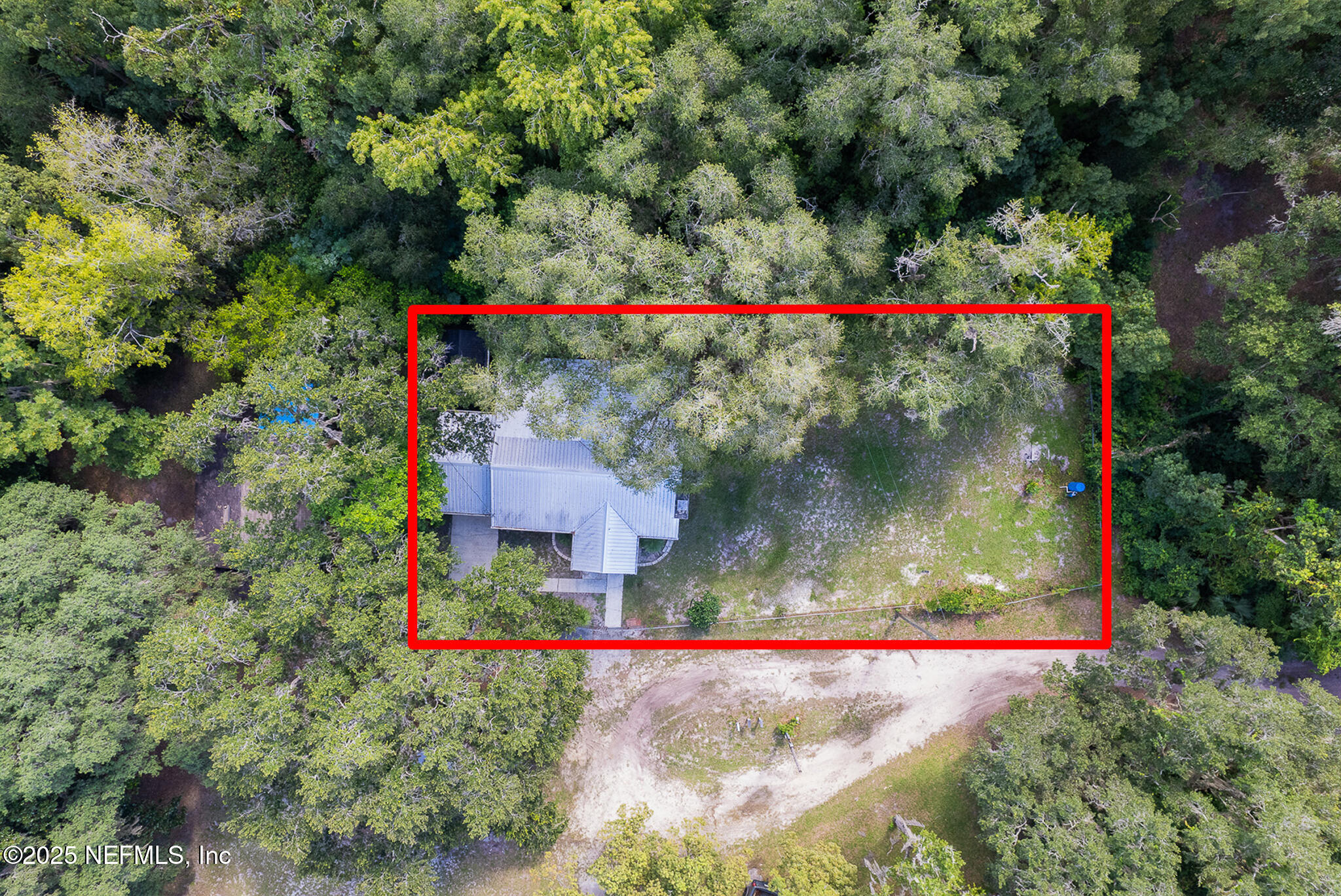 128 Devils Elbow Palatka, FL 32177 - Photo 27 of 38 a view of a wooden house with a yard and trees in the background