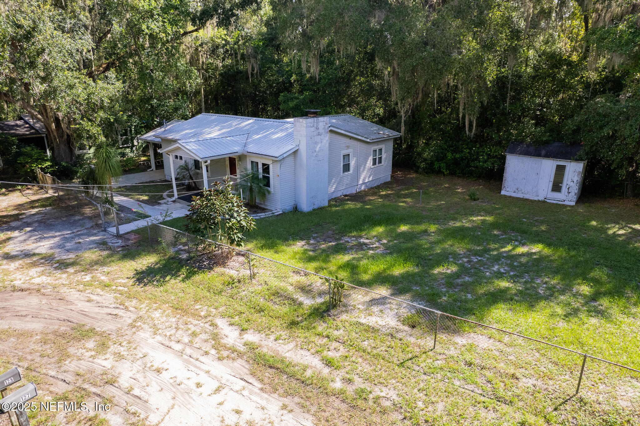 128 Devils Elbow Palatka, FL 32177 - Photo 28 of 38 a backyard of a house with yard and outdoor seating