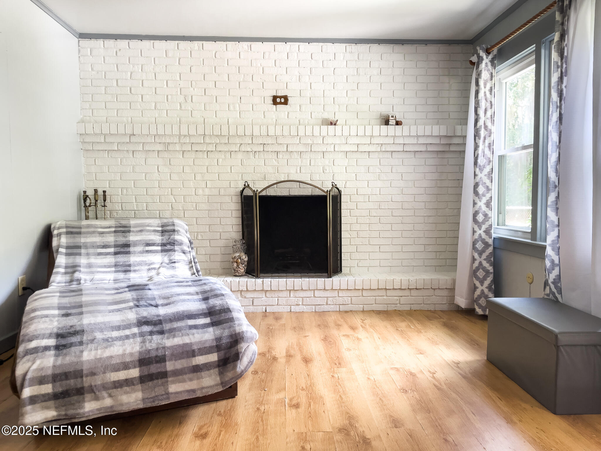 128 Devils Elbow Palatka, FL 32177 - Photo 5 of 38 a bedroom with a bed and a fireplace