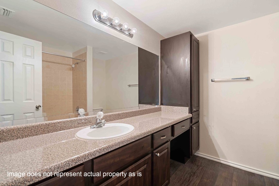 2400-1033 Spring Rain Drive Spring, TX 77379 - Photo 9 of 35 a bathroom with a granite countertop sink and a mirror
