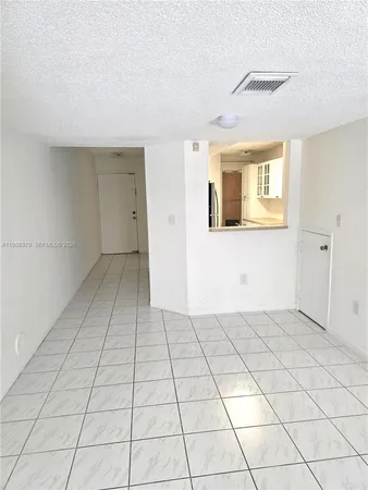 a kitchen with granite countertop a sink a stove top oven and cabinets