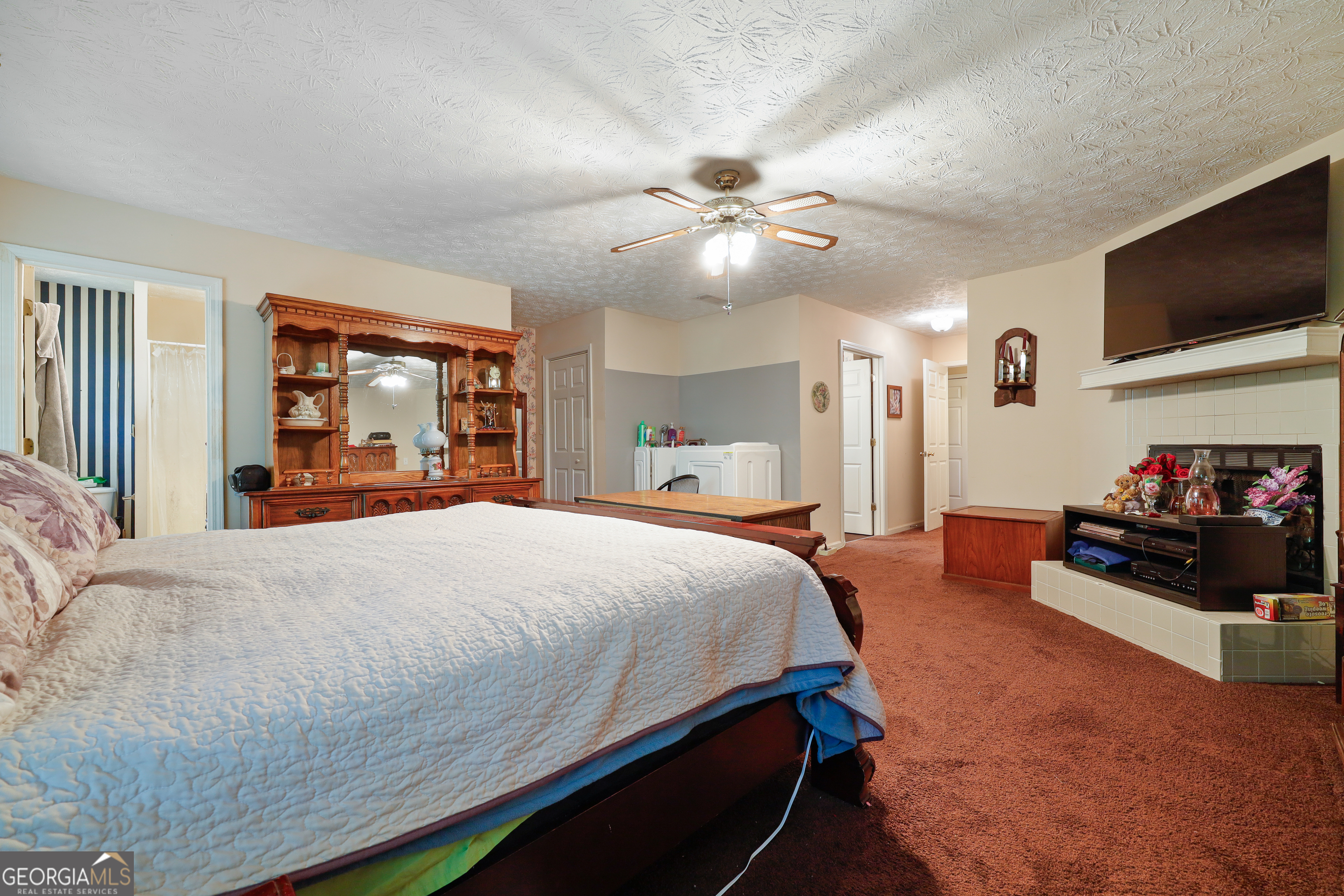 2433 Bear Creek Road Statham, GA 30666 - Photo 22 of 58 a bedroom with a bed and a flat screen tv
