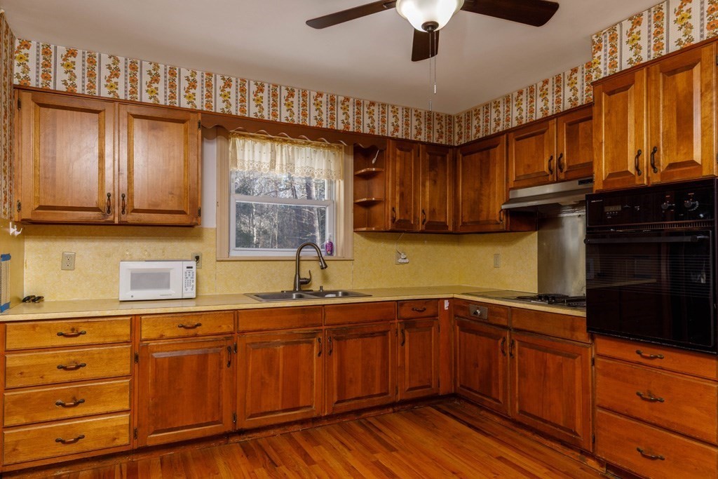 14 Baker Lane Templeton, MA 01468 - Photo 3 of 21 a kitchen with stainless steel appliances granite countertop wooden cabinets a sink and dishwasher