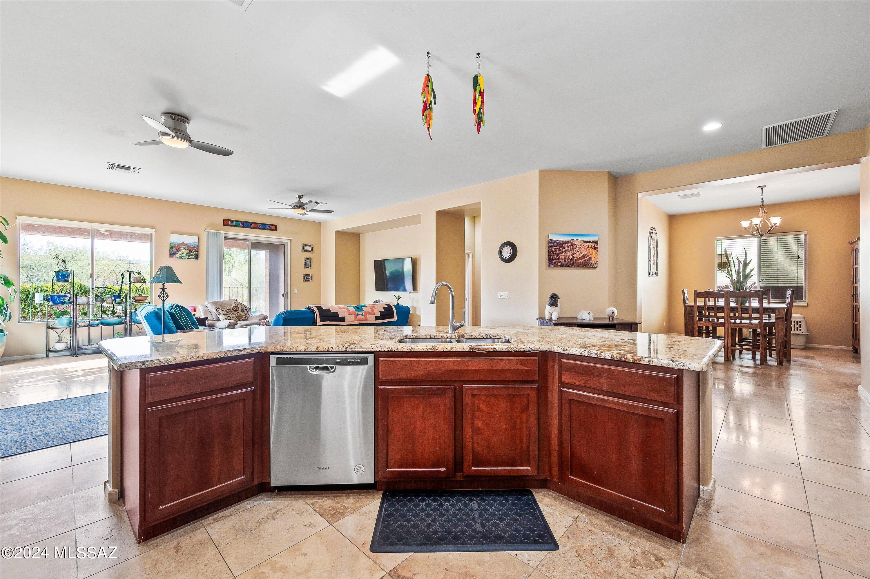 8579 North Shadow Wash Way Tucson, AZ 85743 - Photo 10 of 34 a kitchen with lots of counter top space and living room