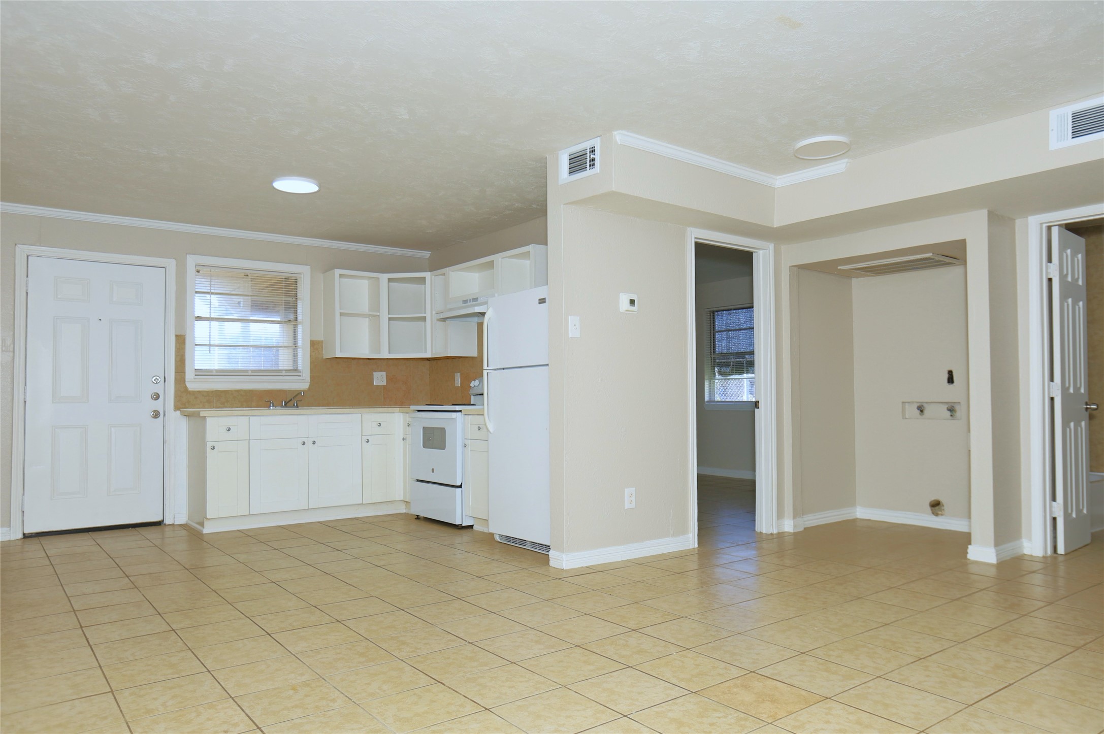 123 West 6th Street Freeport, TX 77541 - Photo 3 of 10 a view of a kitchen with a dishwasher cabinets and a refrigerator