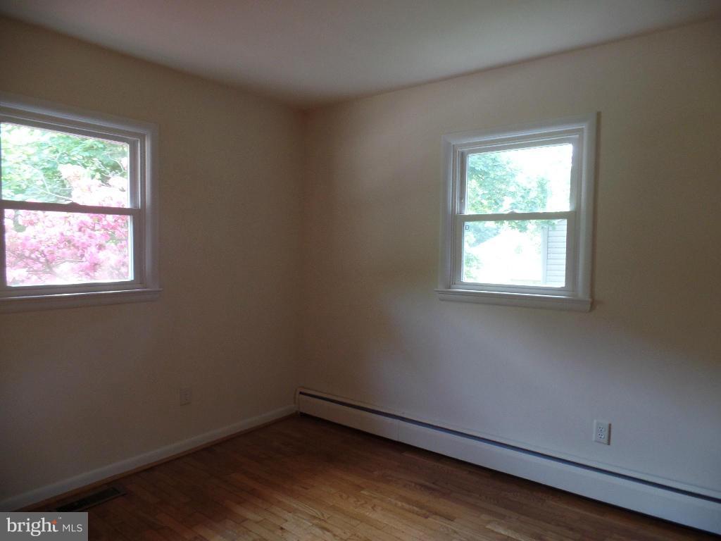 212 Ewingtown Road Church Hill, MD 21623 - Photo 4 of 10 an empty room with wooden floor and windows