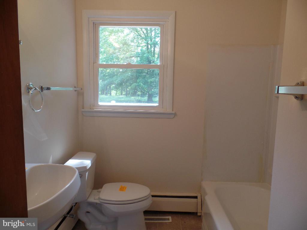 212 Ewingtown Road Church Hill, MD 21623 - Photo 7 of 10 a white toilet sitting next to a bath tub