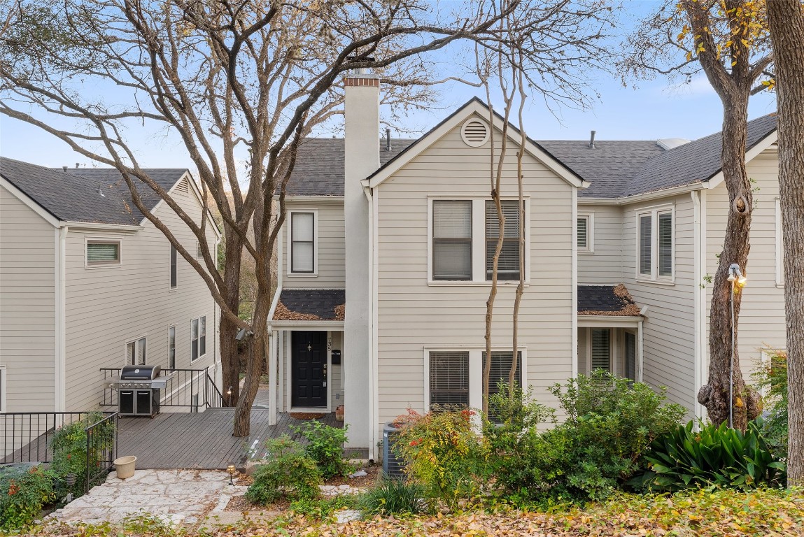 a front view of a house with yard and green space