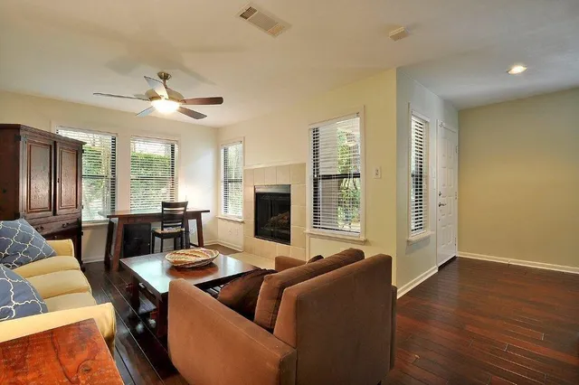 a living room with furniture wooden floor and a fireplace