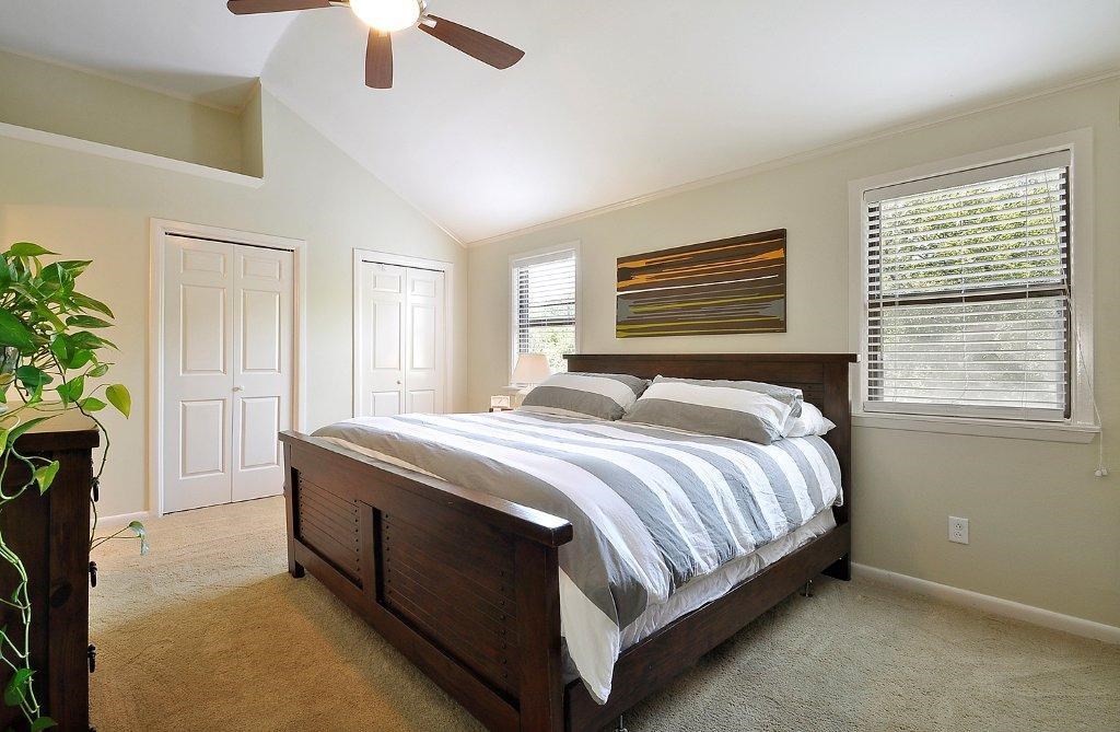 735 Patterson Avenue Austin, TX 78703 - Photo 8 of 15 a bedroom with a bed and a chandelier