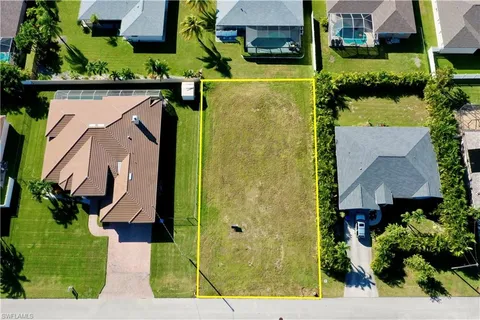 an aerial view of a house with a yard basket ball court and outdoor seating